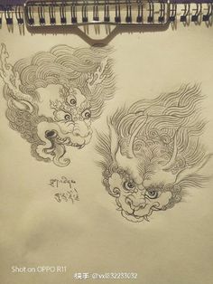 a drawing of two dragon heads on a piece of paper