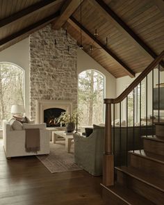 a living room filled with furniture and a fire place in the middle of a room