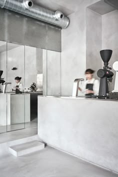 two people are sitting at a counter in a restaurant