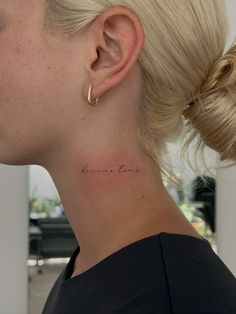 a woman with a small tattoo on her neck