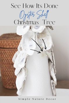 a white vase with flowers on it and the words sea how its done oyster shell christmas tree