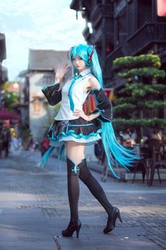 a woman with blue hair is posing on the street