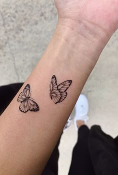 two butterflies tattoo on the wrist