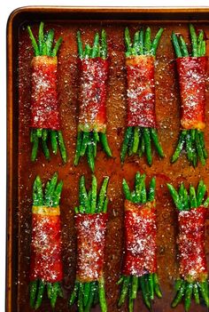 carrots and green beans on a baking sheet covered in sugar sprinkles