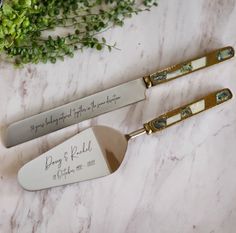 two personalized serving utensils on a marble table