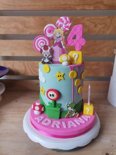 a birthday cake is decorated with candy and characters