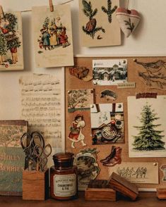 a wooden table topped with lots of pictures and cards