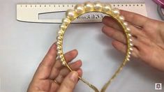 someone is making a beaded headband out of pearls