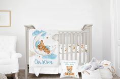 a baby crib with a teddy bear blanket and other items