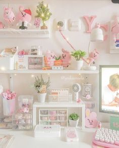 a white desk topped with lots of shelves filled with toys and decorating items next to a computer monitor