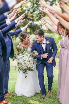 the bride and groom are surrounded by their wedding party