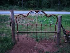 an old iron bed frame in the grass