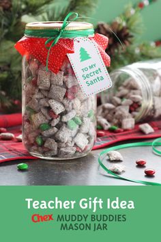 a glass jar filled with christmas candy sitting on top of a table