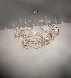 a chandelier hanging from the ceiling in a room with white walls and fog