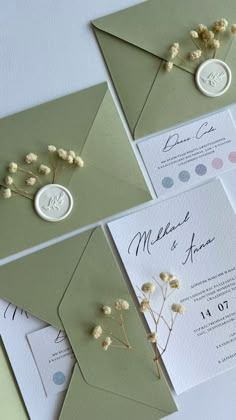 the wedding stationery is laid out on top of each other