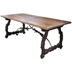 an old wooden table with iron legs and a wood slab on the top, against a white background