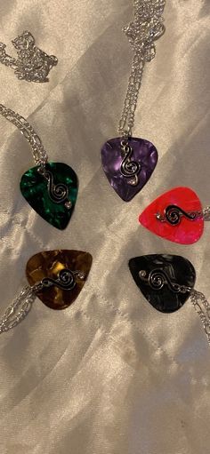 six different colored guitar picks on a silver chain