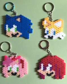 four perler keychains made to look like cartoon characters