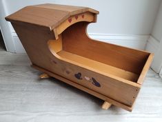 an old wooden toy piano with hearts painted on the front and sides, sitting in a corner