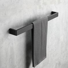 a towel is hanging on the wall next to a towel rack with two black handles