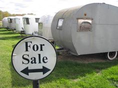 a for sale sign in front of some trailer trailers