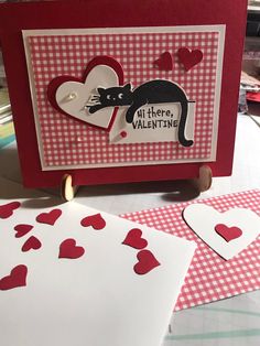 valentine's day card made with stamping paper and heart shapes on the table