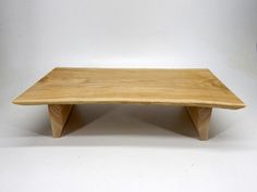 a small wooden table sitting on top of a white floor