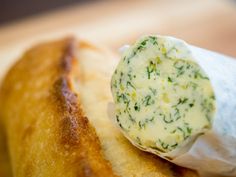 a piece of bread with cheese and herbs on it