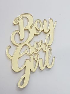 the word boy and girl written in gold foil on a white background with an inscription below it