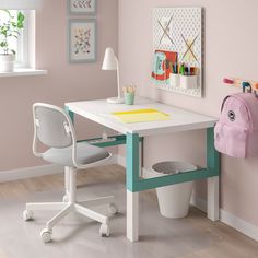 a child's desk and chair in a room with pink walls