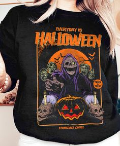 Stay spooky all year long with our 'Everyday is Halloween' Unisex Sweatshirt. Featuring a zombie pumpkin design, this sweatshirt is perfect for any Halloween lover. Made from quality materials, stay comfortable and stylish while embracing the Halloween spirit. · Everyday is Halloween · 50% Cotton; 50% Polyester · Loose fit · Runs true to size · Original design Printed on Gildan sweatshirts. Care Instructions: Machine wash warm. Non-chlorine: bleach as needed. Tumble dry medium heat. Do not iron. Affordable Halloween Graphic Print T-shirt, Vintage Halloween Shirt, Halloween T Shirt Design, Zombie Pumpkin, Everyday Is Halloween, Vintage Spooky, Goth Halloween, Stay Spooky, Fantasy Wardrobe