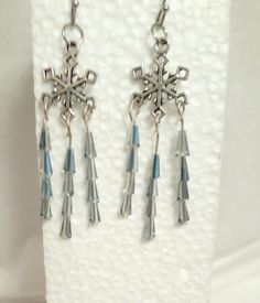 a pair of earrings with tassels hanging from them