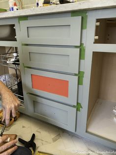 a man is working on an unfinished cabinet