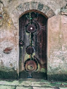 an old wooden door with metal decorations on it