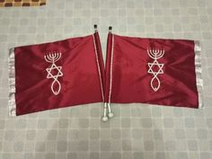 two red flags with menorah symbols on them sitting next to each other in a room