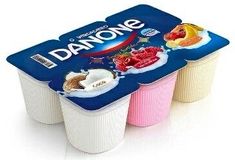 three yogurt cups with different toppings on them, one is blue and the other has pink