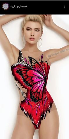 a woman in a red and black bodysuit with butterfly wings on it's chest