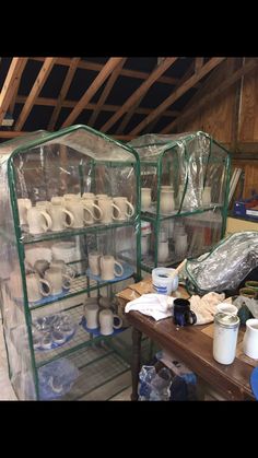 two shelves filled with lots of toilet paper on top of a wooden table in a room