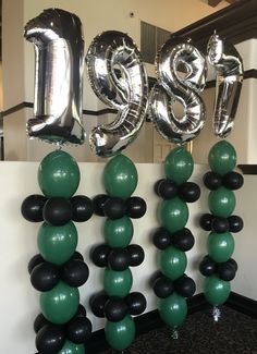 balloons and streamers are arranged in the shape of numbers