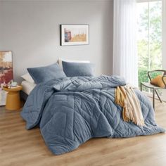 the comforter is made up and ready to be used in the bedroom or living room