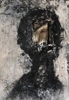 the shadow of a man's head is seen through a hole in an old wall