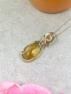 This wire wrapped citrine pendant features a deep gold oval citrine cabochon wire wrapped in 14k gold filled wire. About the Pendant: - 100% handmade - Genuine, natural citrine  - Non-tarnish 14k gold filled wire - Safe for daily wear - Suitable for those with metal allergies or sensitivities - One-of-a-kind piece A 14k gold filled chain will be included with the pendant.  The piece will ship in a pendant box and will include care instructions in the package.  The piece will be professionally po Wire Wrapped Crystal Pendant, November Birthstone Necklace, Handmade Crystal Jewelry, Bijoux Fil Aluminium, Citrine Jewelry, Citrine Pendant, Citrine Necklace, Wire Wrapping Crystals, Natural Citrine