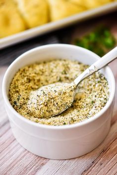 garlic bread seasoning in a white bowl with a spoon