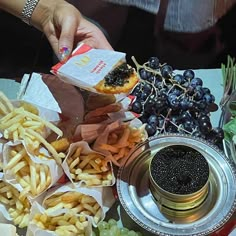 a table topped with lots of different types of food and condiments on top of it