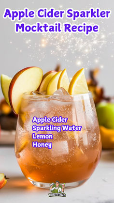 apple cider sparkler cocktail recipe in a glass with apples and lemons on the side