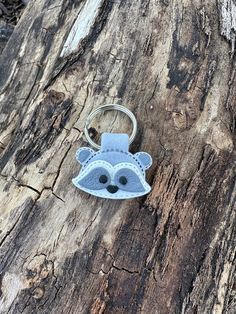 a keychain that has been made to look like a face on a tree