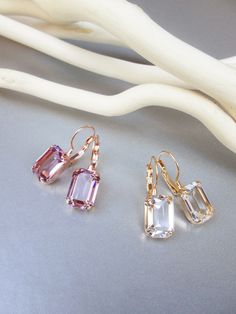 "These elegant little earrings are made with fancy emerald cut transparent Swarovski crystals. Beautifully delicate and chic. Available in gold, rose gold or silver finish. Available in 6 colors. Shown in the video in clear crystal color. - 1\" long from the top of the ear wire to the bottom of the earring - 3/8\" wide - Leverback" Emerald Cut Drop Earrings, Earrings Emerald, Gold Bridesmaids, Crystal Bridal Earrings, Amethyst Color, Pearl Hoop Earrings, Wedding Jewelry Earrings, Bridal Pearls, Delicate Earrings