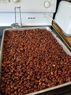 a pan filled with nuts sitting on top of a stove next to an appliance