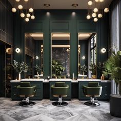 the interior of a modern salon with green chairs and marble counter tops, lights hanging from the ceiling