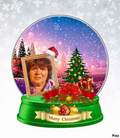 a snow globe with a woman's face in the center and christmas decorations around it